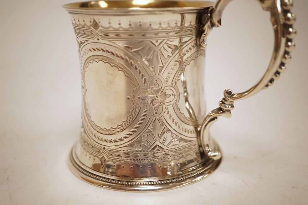 A Victorian bright cut engraved silver christening mug, of waisted form, with engraved inscription and beaded handle, Samuel Roberts & Charles Belk, Sheffield, 1867, 82mm, 5.2oz.